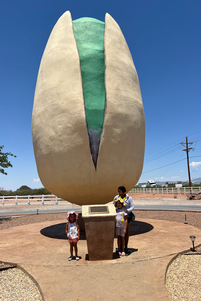 Family standing in front of the world’s largest pistachio.