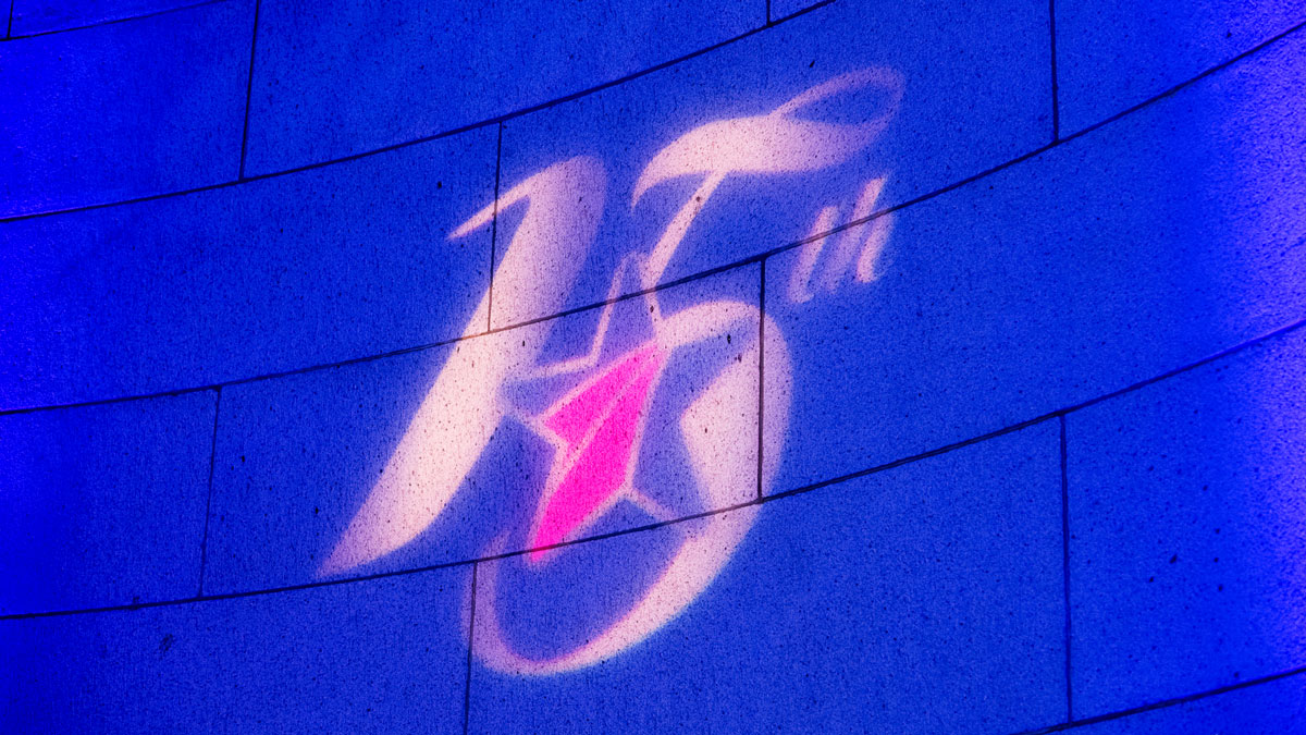 The Blue Star Families 15th Anniversary logo is projected onto a blue background.