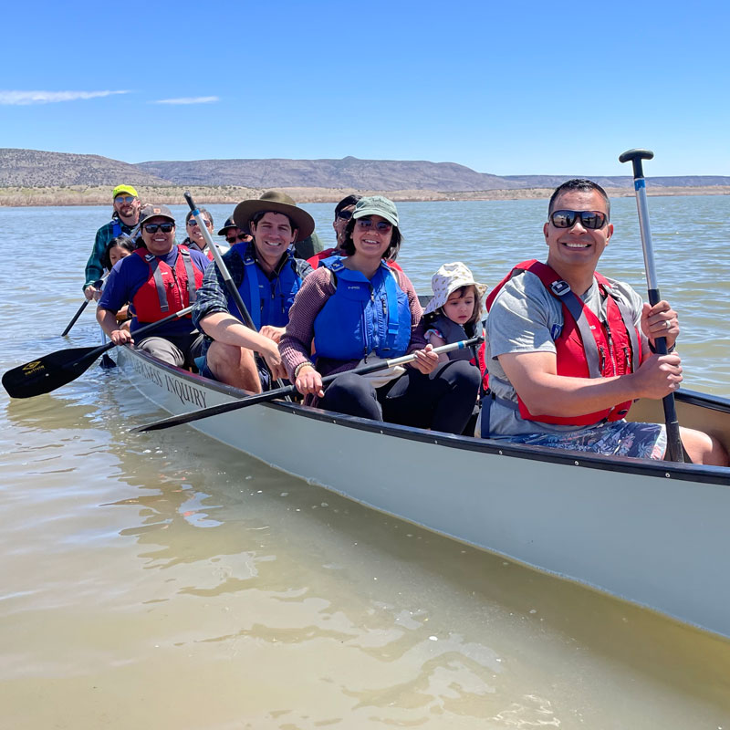 multiple families canoeing at Cochiti Lake