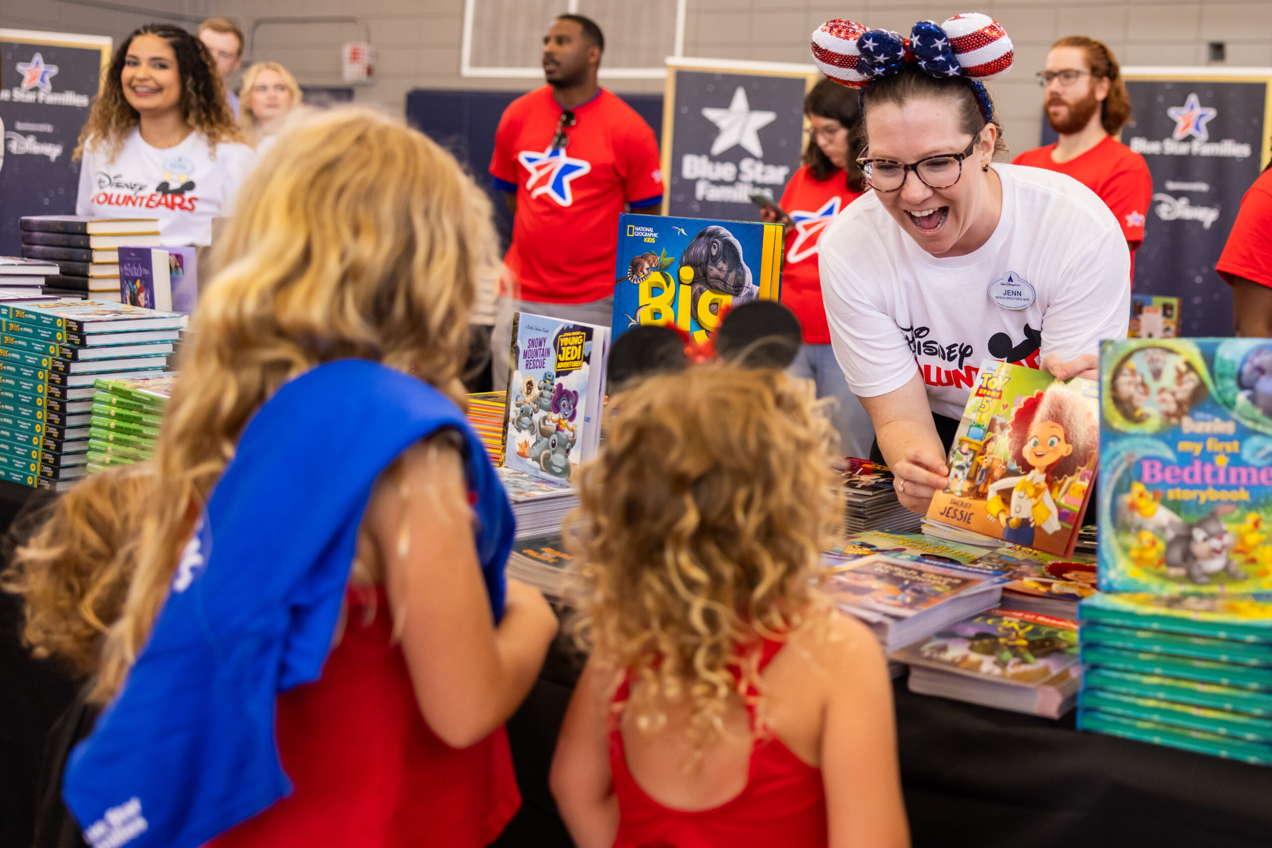 Tampa, Fla. (June 16, 2026) -- Children of service members stationed at MacDill Airforce Base receive Disney books and Mickey Mouse plush during a Blue Star Books event. For nearly 15 years, Disney has supported Blue Star Families’ “Blue Star Books” program, donating more than 370,000 books to enrich military families as part of its ongoing commitment to supporting those who serve and their families. (The Walt Disney Company/Olga Thompson)