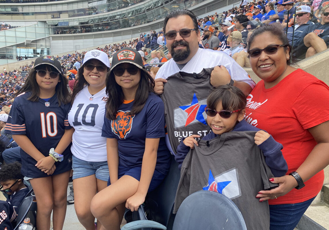 Group of adults with arms around each other showing support.