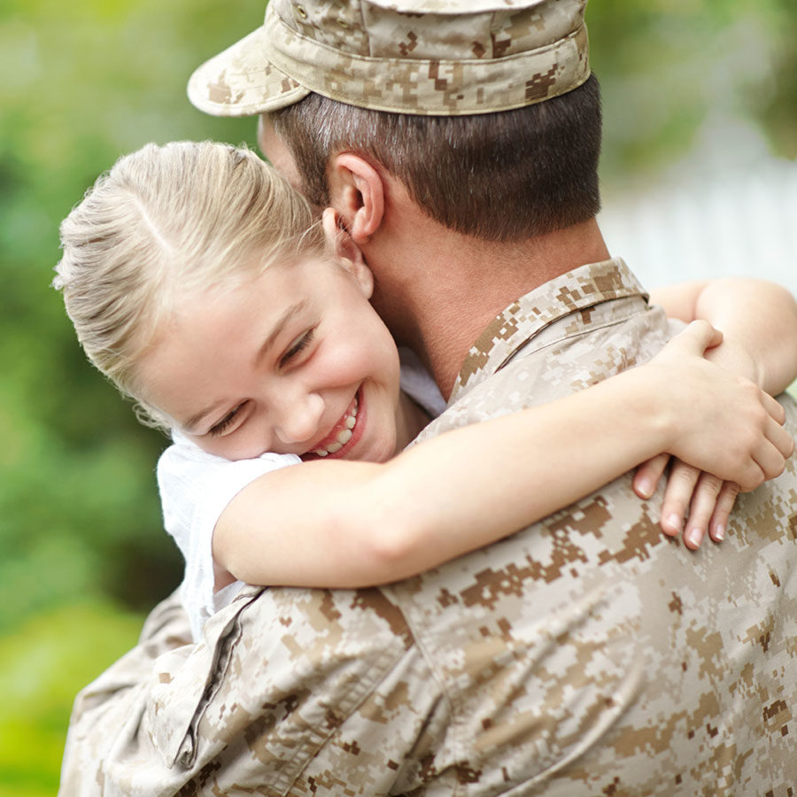 Sweet military kid is hugging her father who is back from the army.