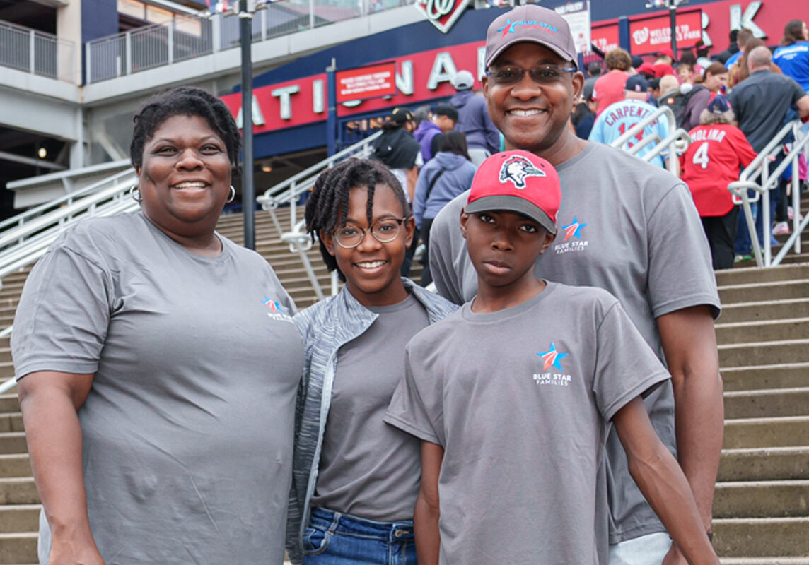 Group of adults with arms around each other showing support.